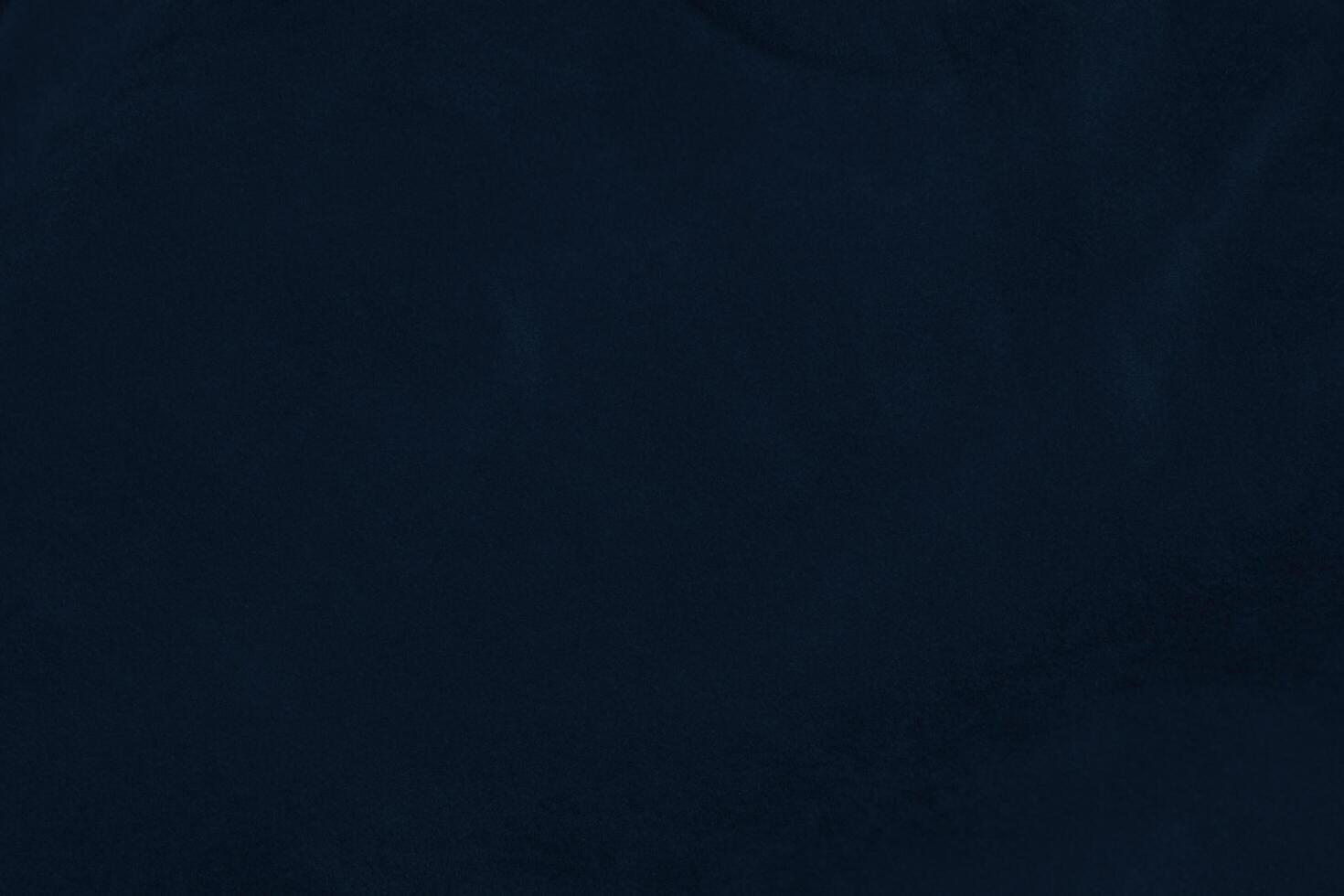 Dark blue velvet fabric texture used as background. silk color denim fabric background of soft and smooth textile material. crushed velvet .luxury navy blue dark tone for silk. photo