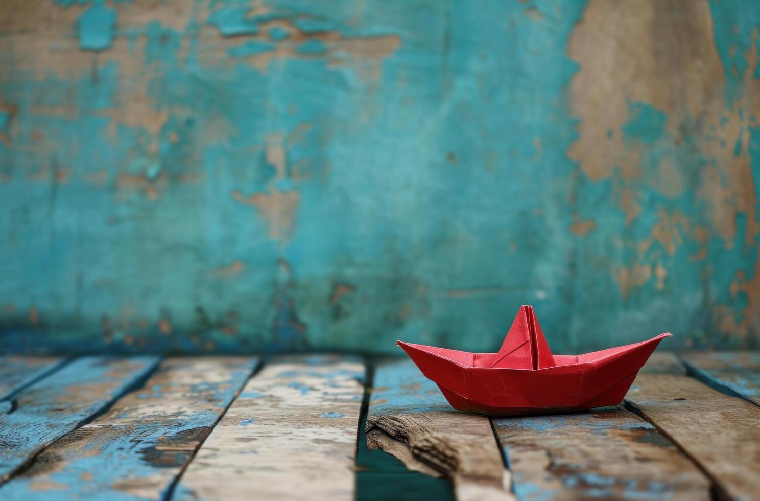 AI generated a small paper boat with red sail on wooden deck photo