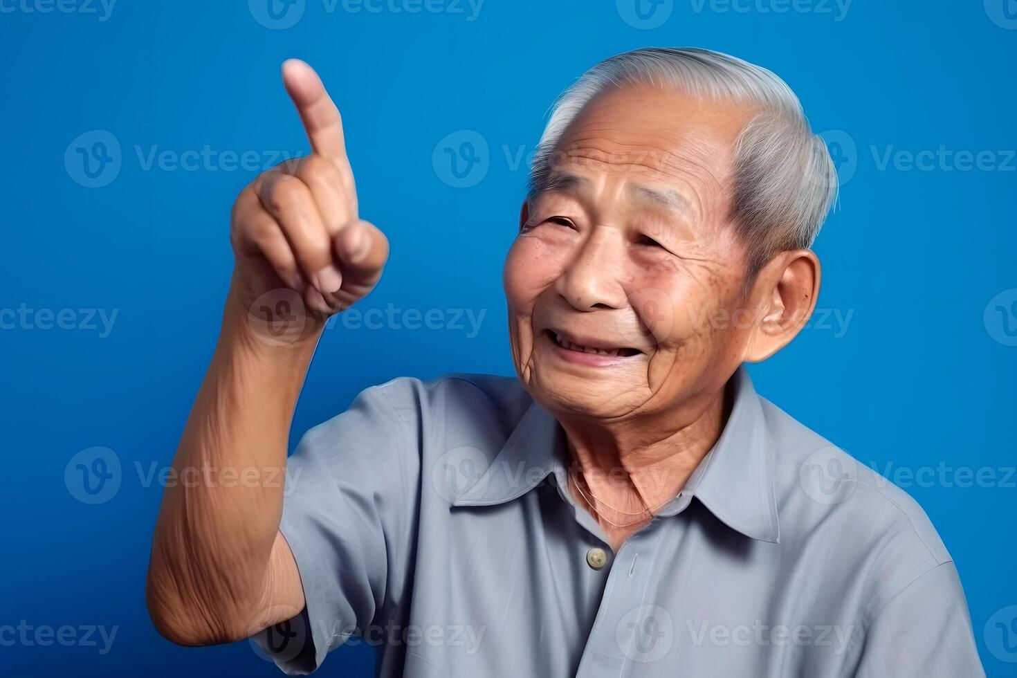AI generated Asian grandfather looking and smiling with rised index finger on blue background, neural network generated art photo