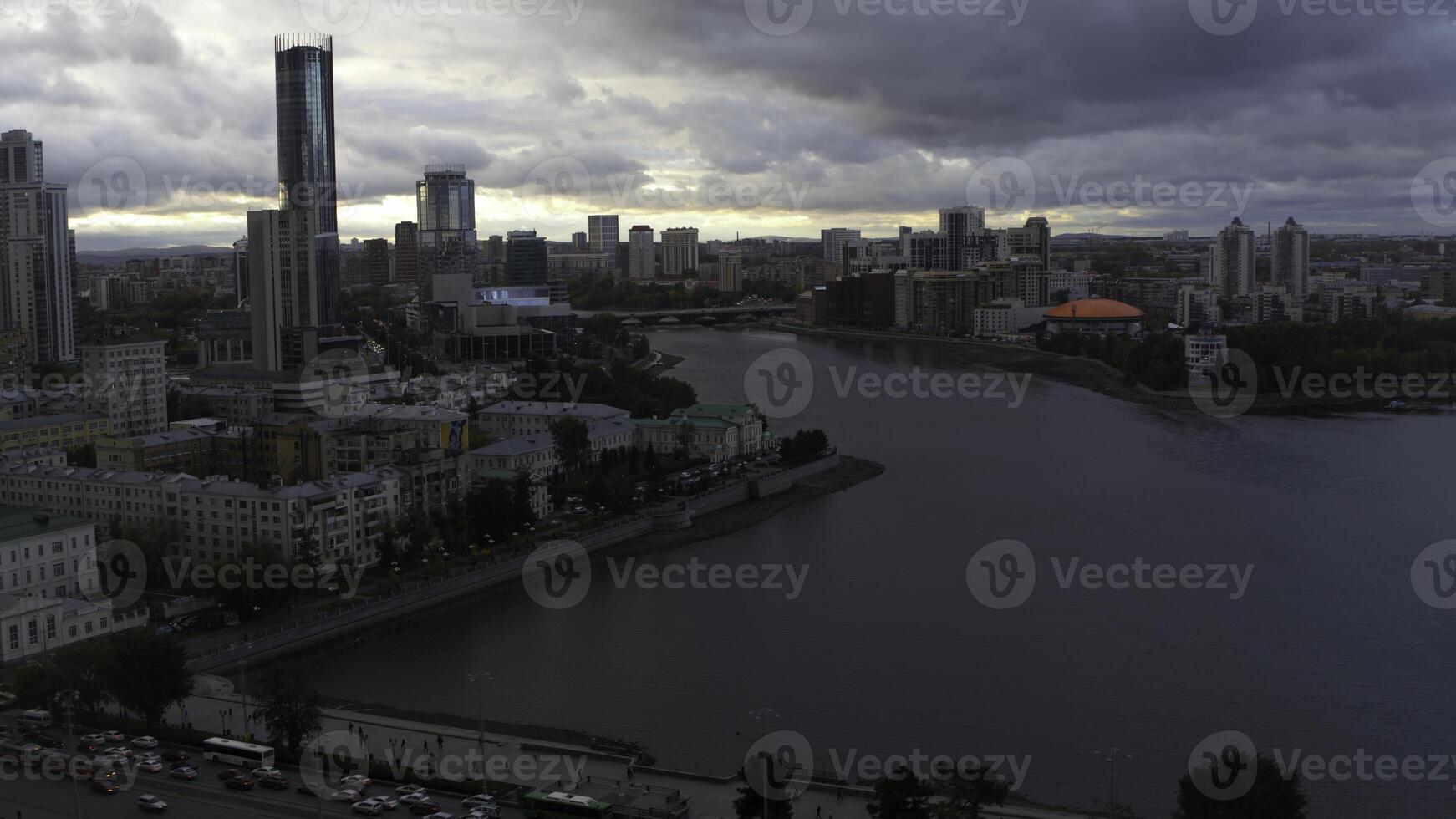 Grey city.Stock footage.Drone view of a big city with various beautiful buildings and a long dirty river and visible gray clouds over the city. photo