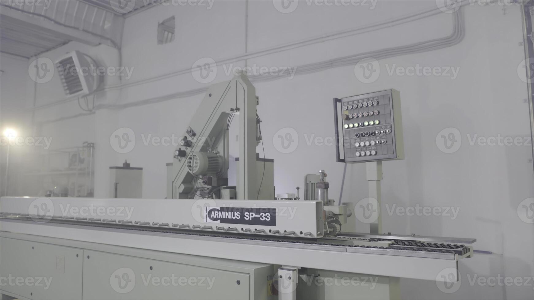 Modern equipment for woodworking in shop. Action. Closed belt machines for cutting or grinding wooden boards. Woodworking equipment of modern automated type photo