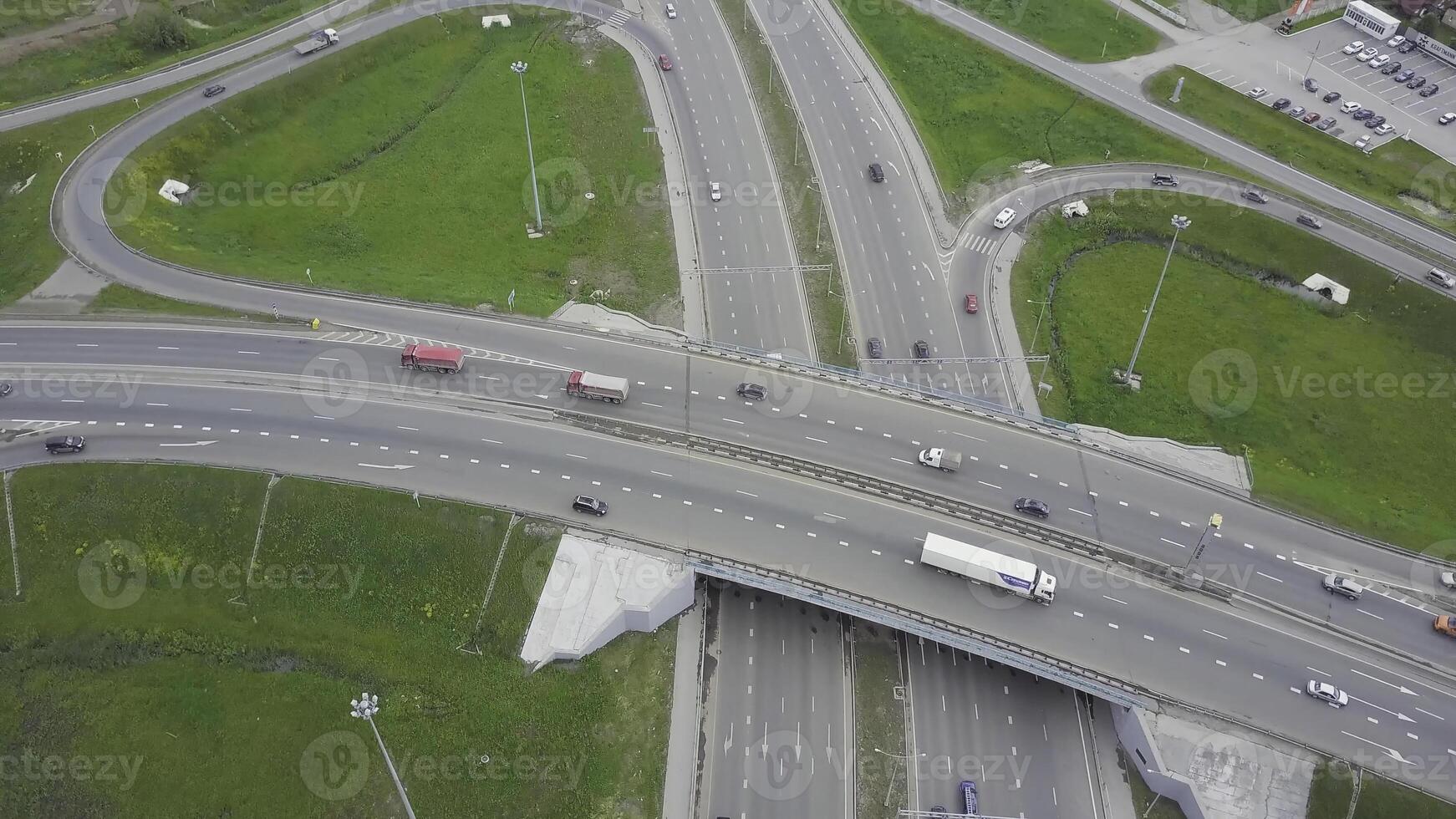 Aerial view of a freeway intersection. Clip. Highway and overpass with cars and trucks, interchange, two-level road junction in the big city. Top view. photo