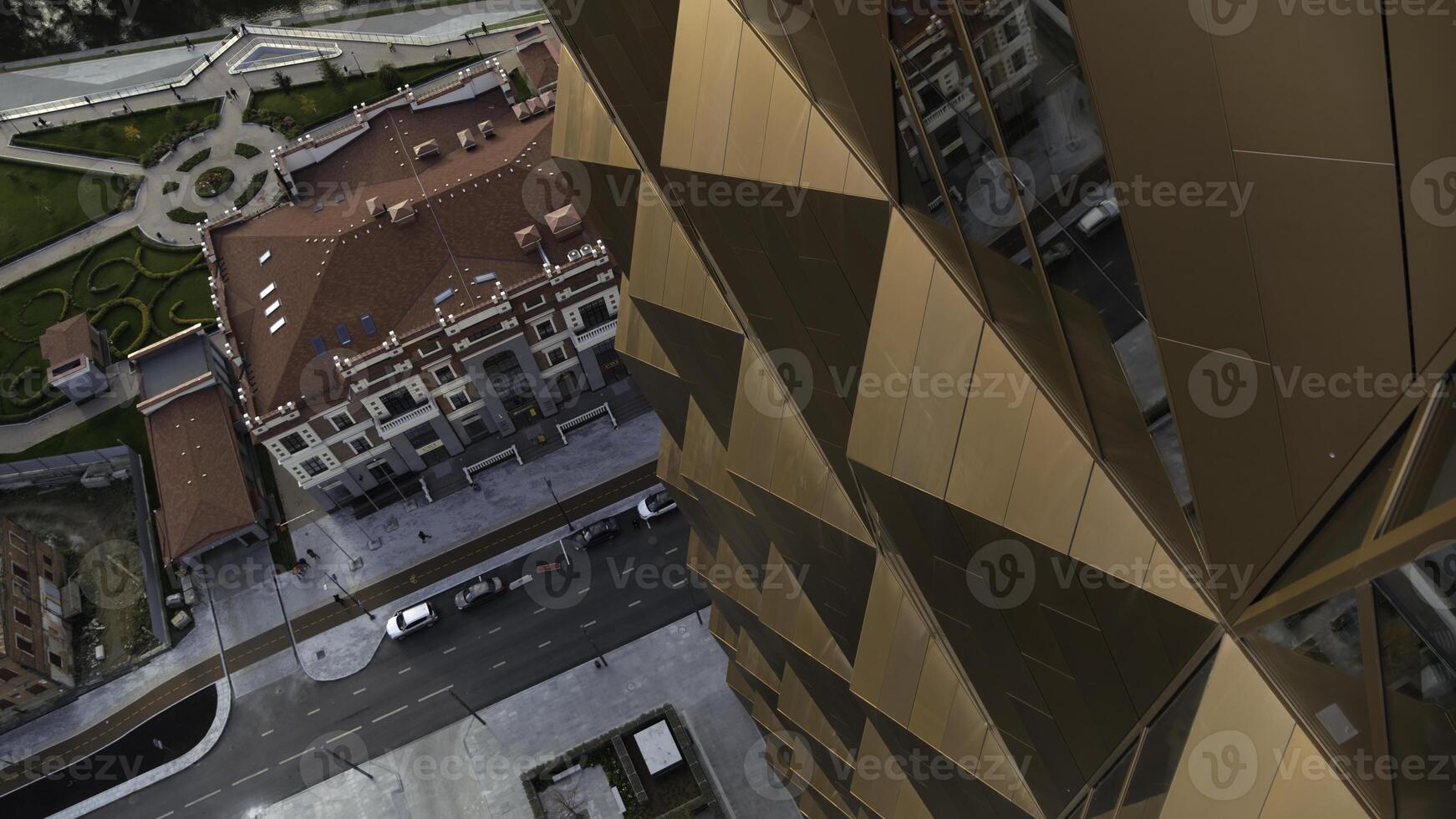 Aerial top down view of bronze skyscraper or office building. Stock footage. Summer cityscape. photo