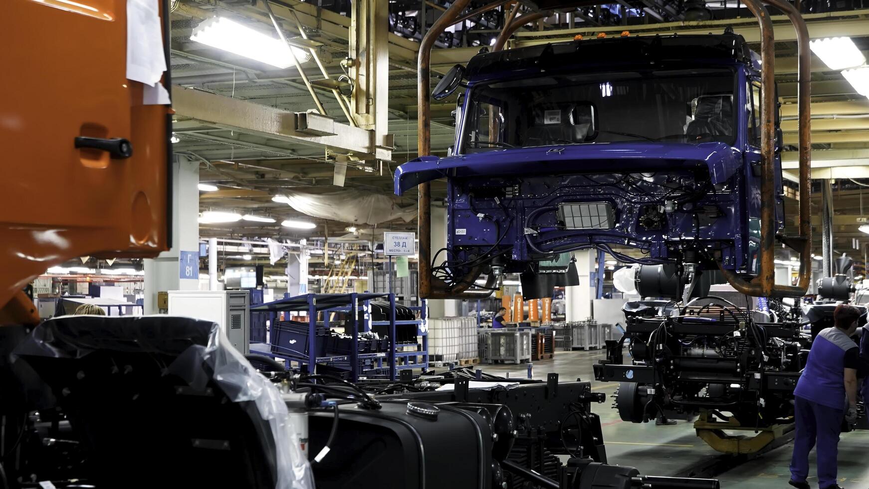 Russia - Moscow 5 March 2020. Automobile assembly line production at the Kamaz truck factory. Scene. Time lapse effect, industrial background with body frame hanging line, mechanical engineering photo