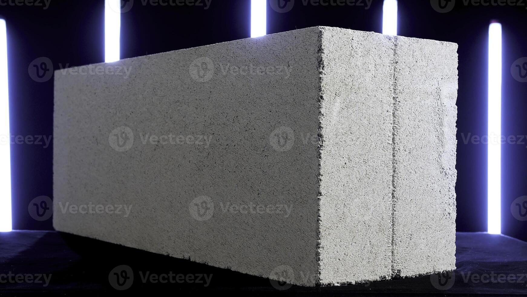 Demonstration of white concrete block on black background with sveral blue neon lamps. Stock footage. Close up of concrete slab, construction materials concept. photo