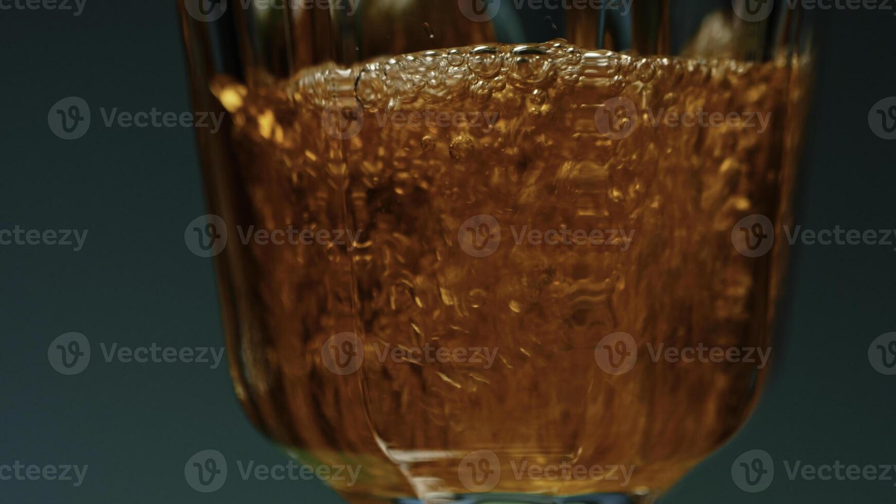 Close up of pouring ice tea cold refreshing drink into the transparent glass. Stock clip. Drinking at party concept. photo