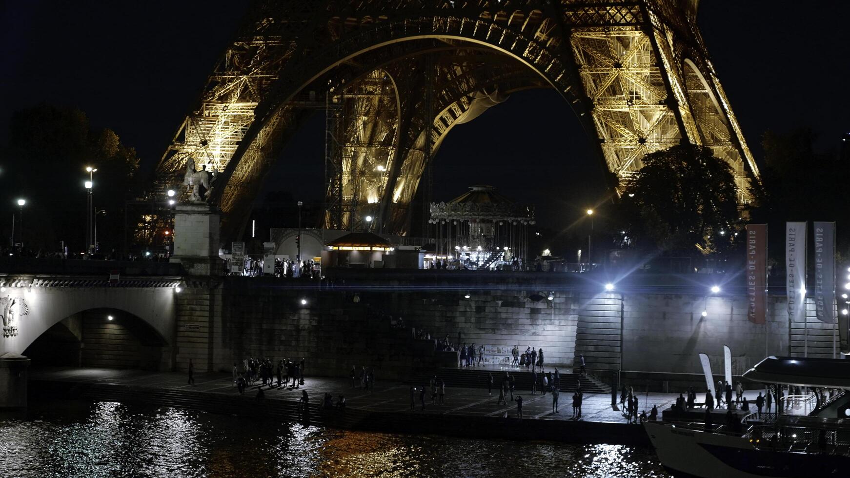 France, Paris - September 10, 2022. Eiffel tower in paris. Action. Beautiful night city with embankment and famous tower. Famous tourist spot at base of Eiffel Tower photo