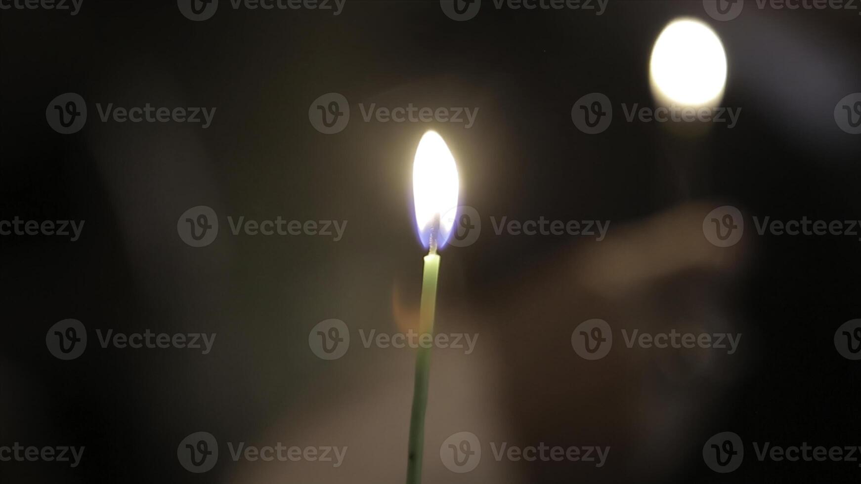 Lighting A Candle With A Match To Get A Romantic Candlelight. Amazing andles and candlesticks are on the table. Stay lights with the peaceful background of religious ceremony. photo