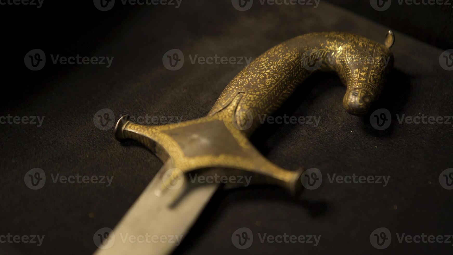 Close-up of patterns of handle of medieval weapon. Stock footage. Ancient weapons of Slavic or Eastern people in Museum on isolated background photo