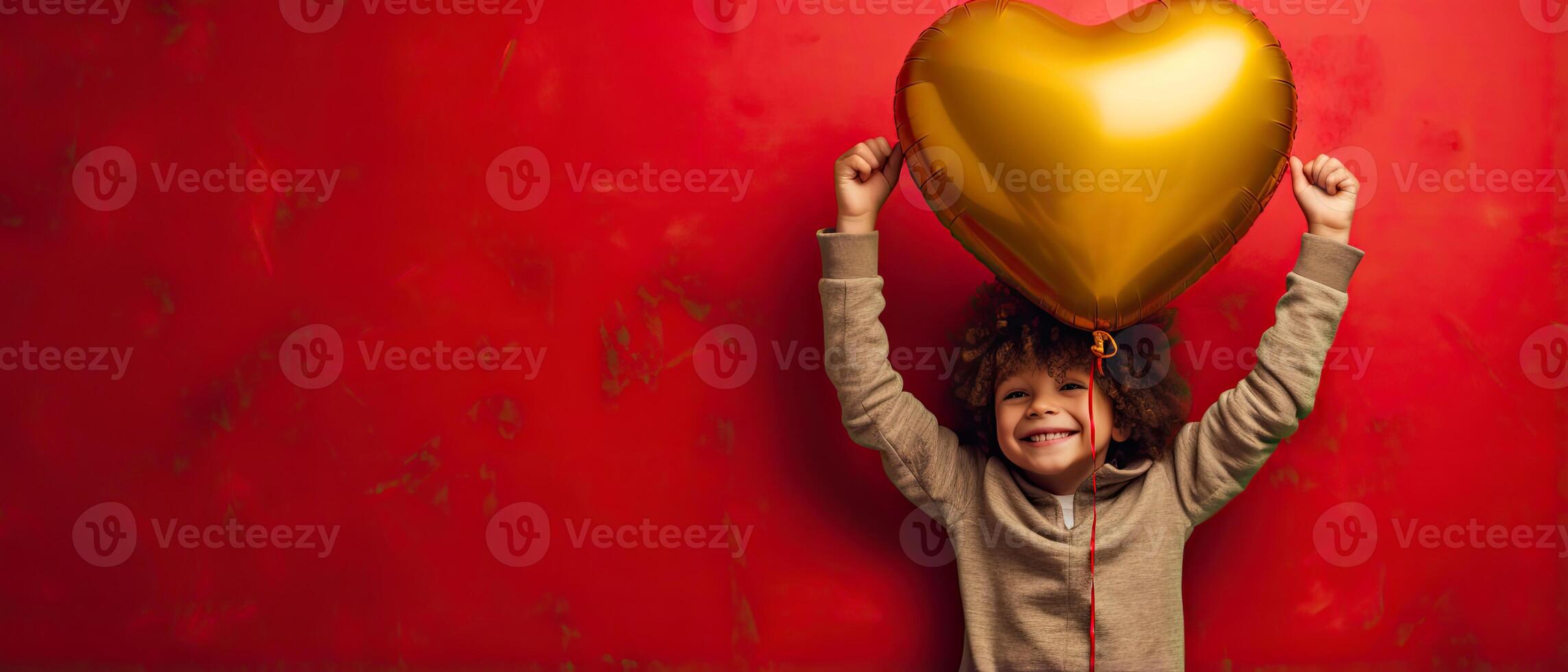 AI generated Front view of a kid with gold yellow heart shaped balloon on red background photo