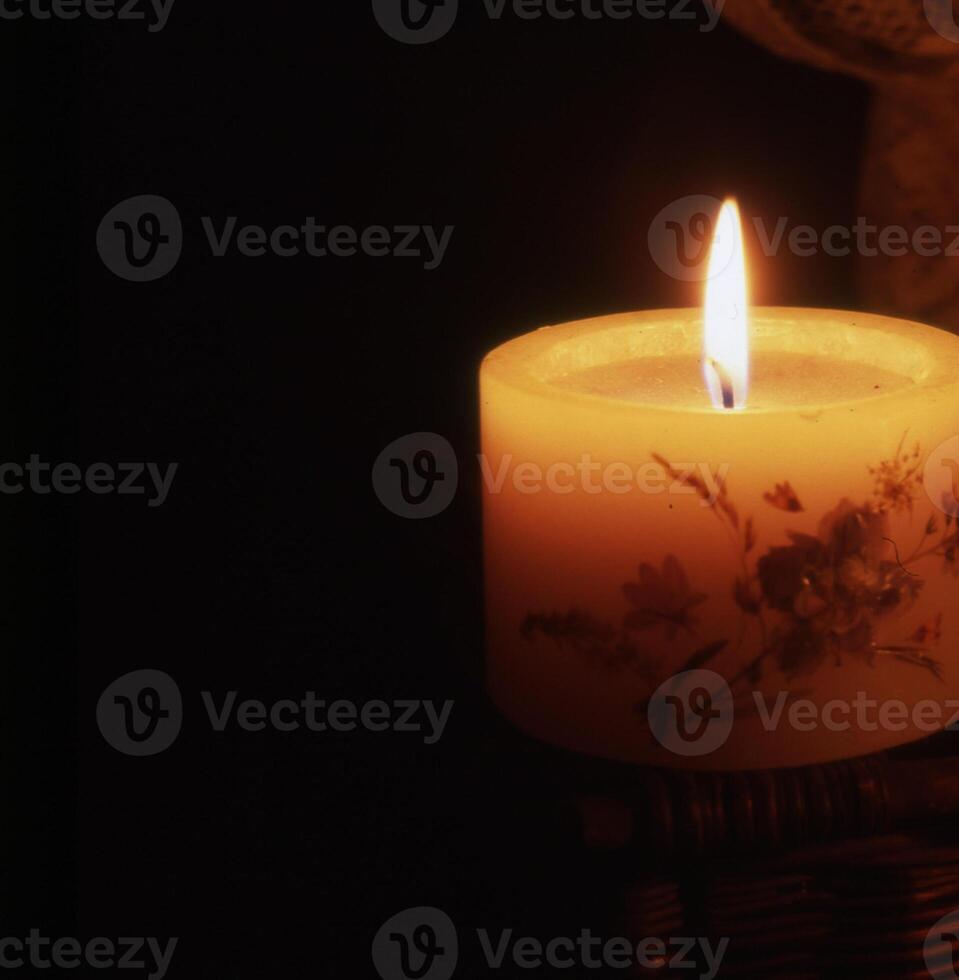 a candle is lit in the dark photo