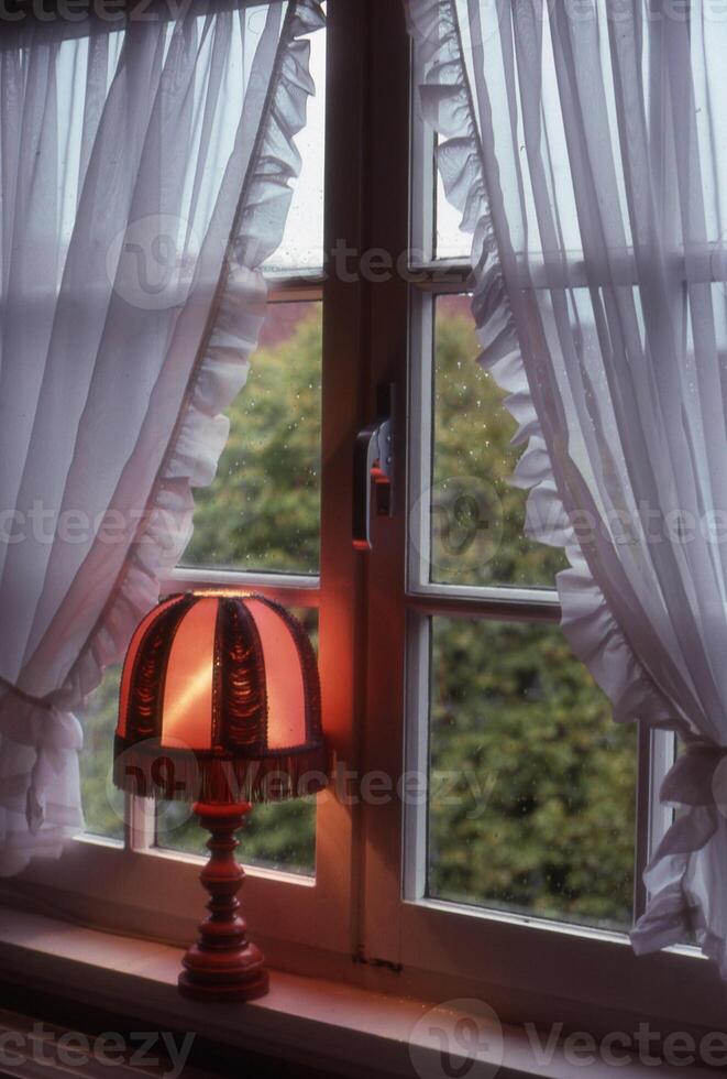 a lamp sitting on a window sill photo