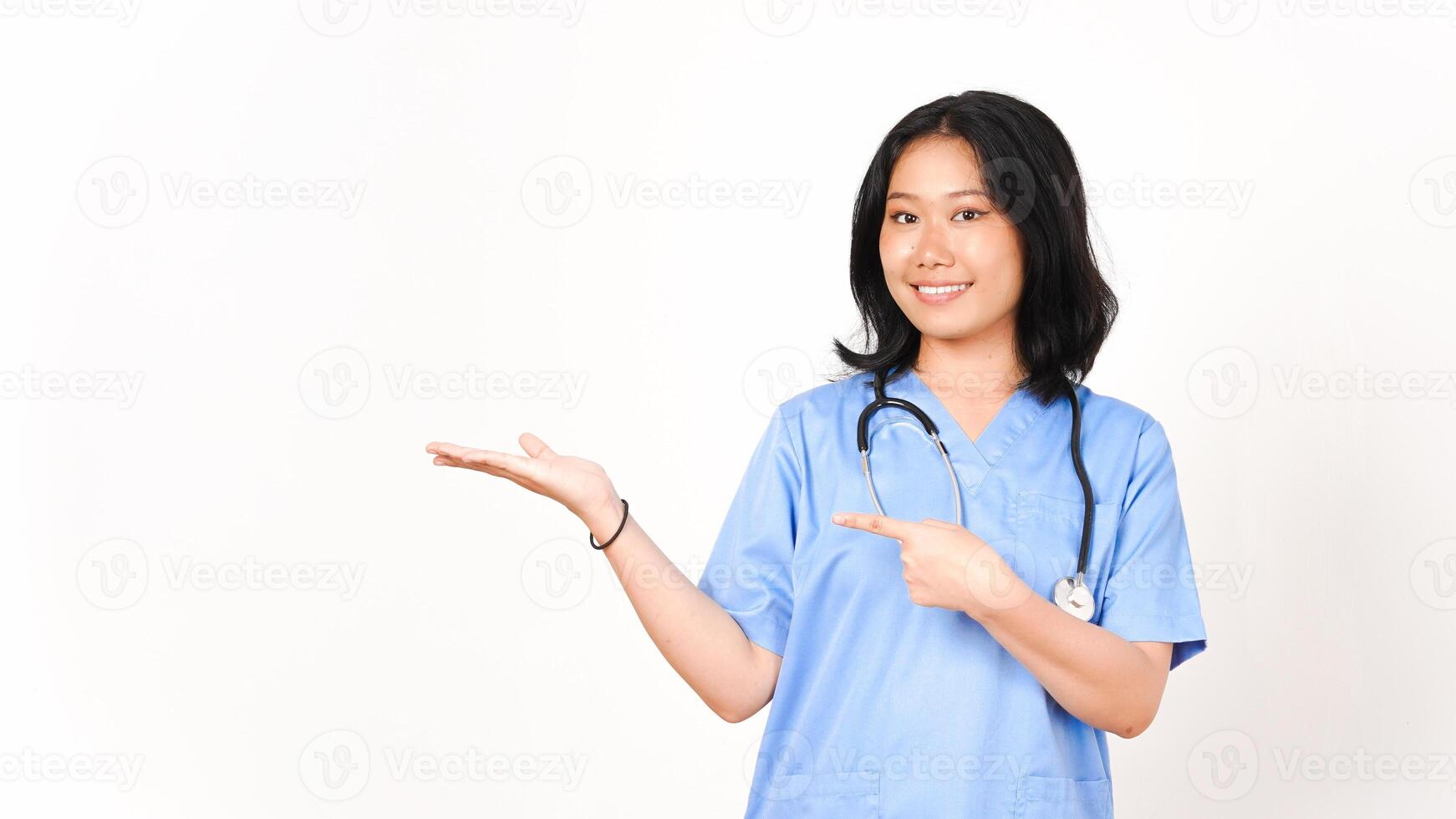 Young Asian female doctor pointing copy space on palm hand isolated on white background photo