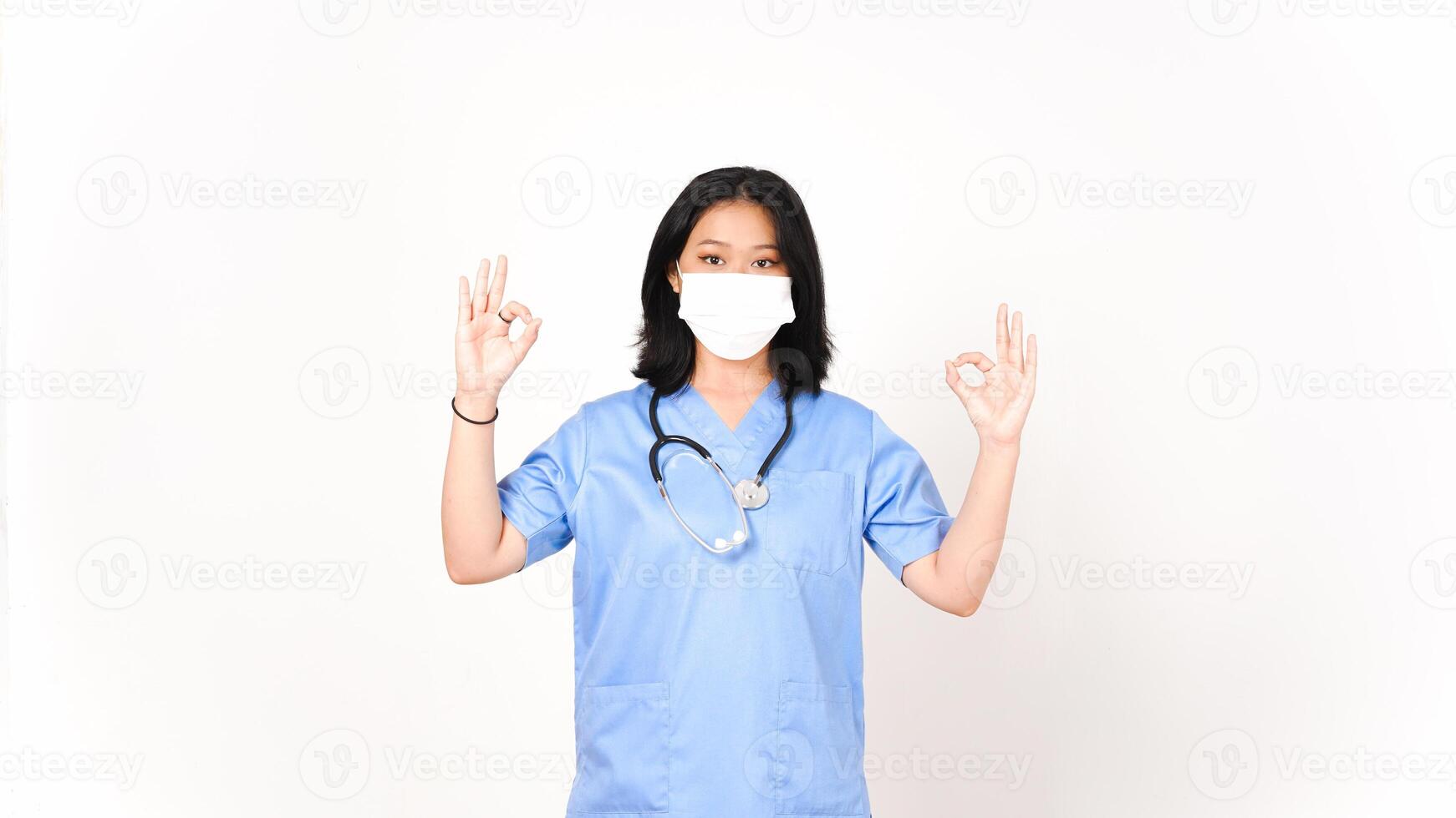 Young Asian female doctor showing okay sign isolated on white background photo