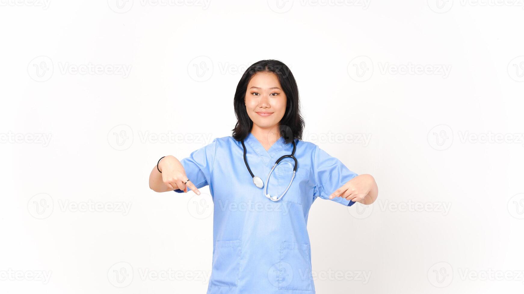 Young Asian female doctor pointing bellow copy space isolated on white background photo