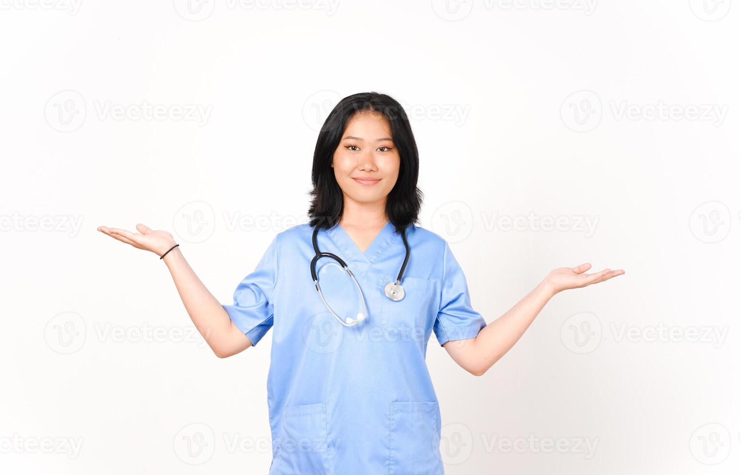 Young Asian female doctor showing copy space on two open palm isolated on white background photo