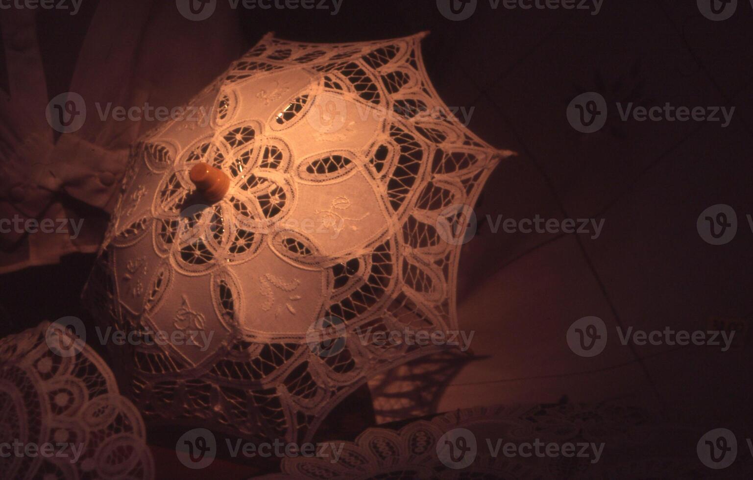 a close up of a white umbrella with lace photo