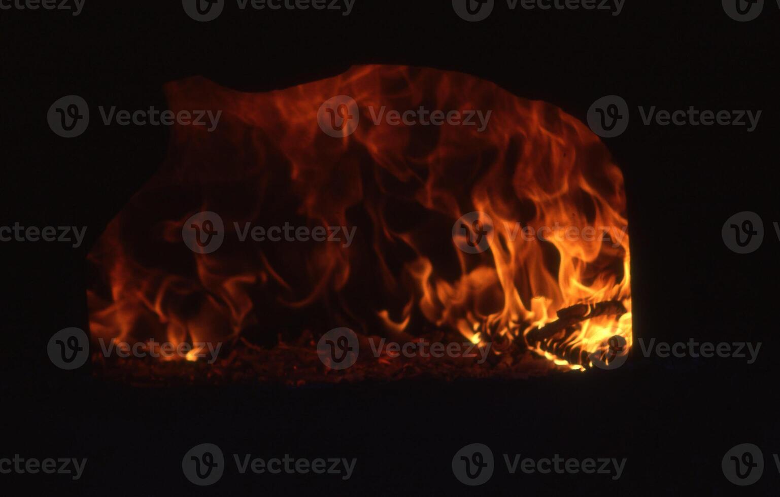 a fire is burning in a fireplace photo