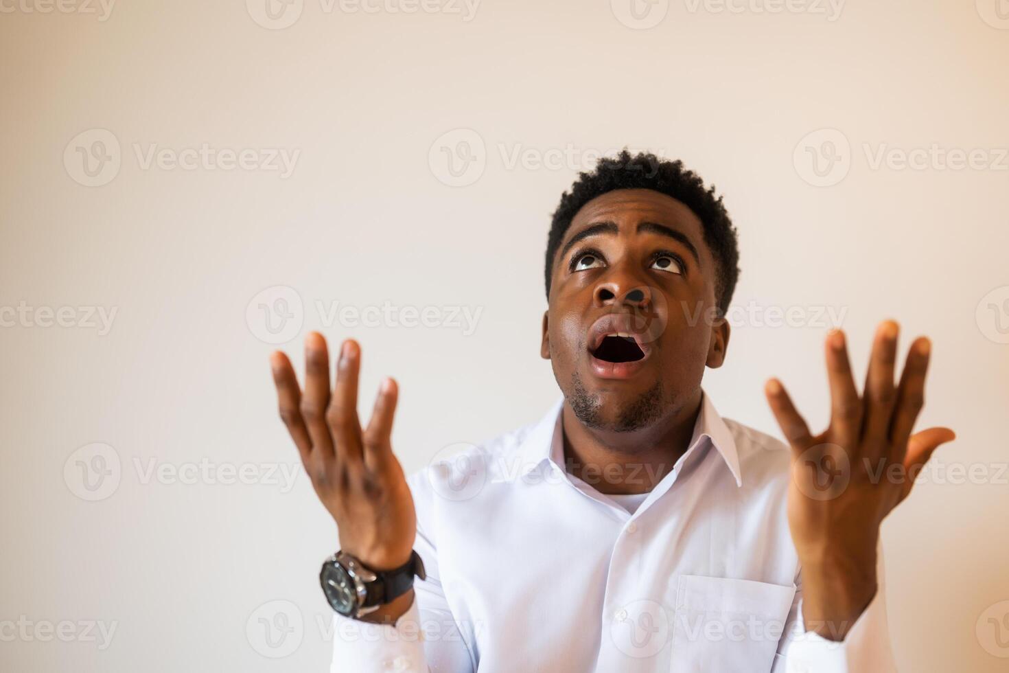 Portrait of young businessman who is disappointed and anxious. He is praying. photo