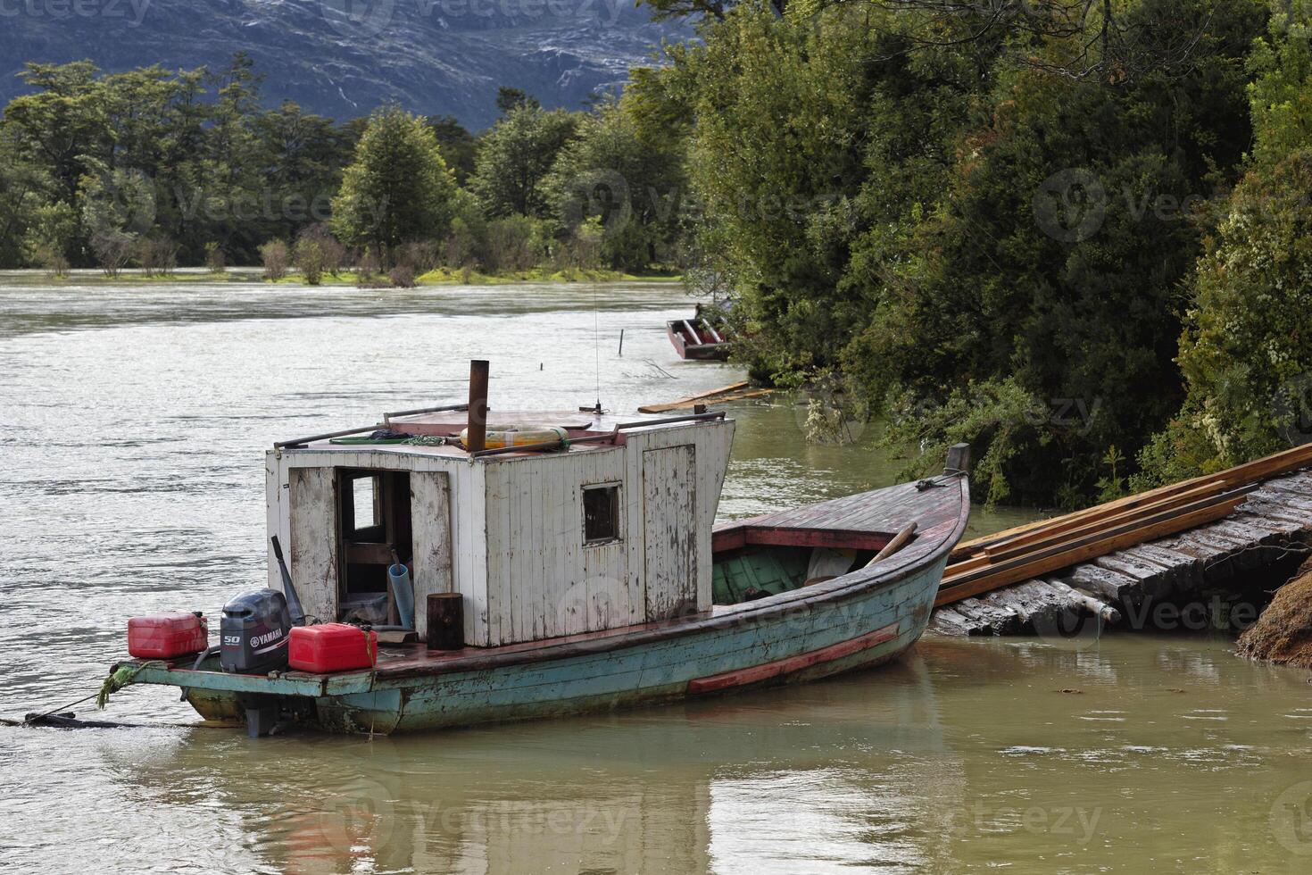 Tortel, Chile, 2019 - Anchored Boat, Caleta Tortel, Aysen Region, Patagonia, Chile photo