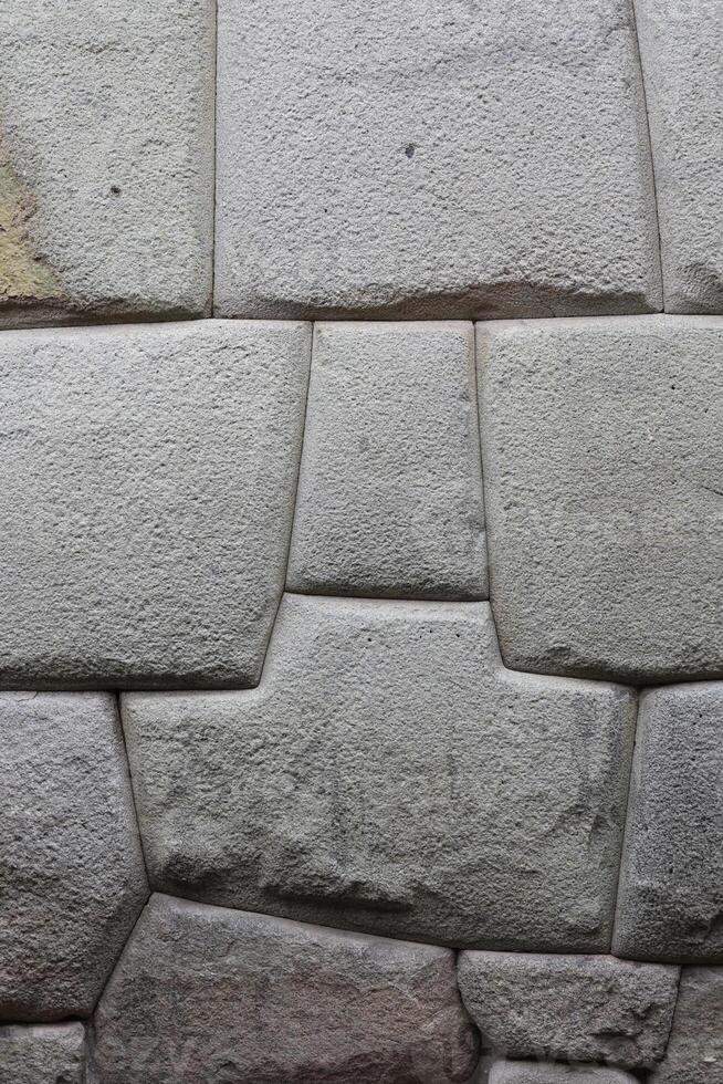 Stone Inca masonry in the wall of the archbishop residence, Cusco, Peru photo