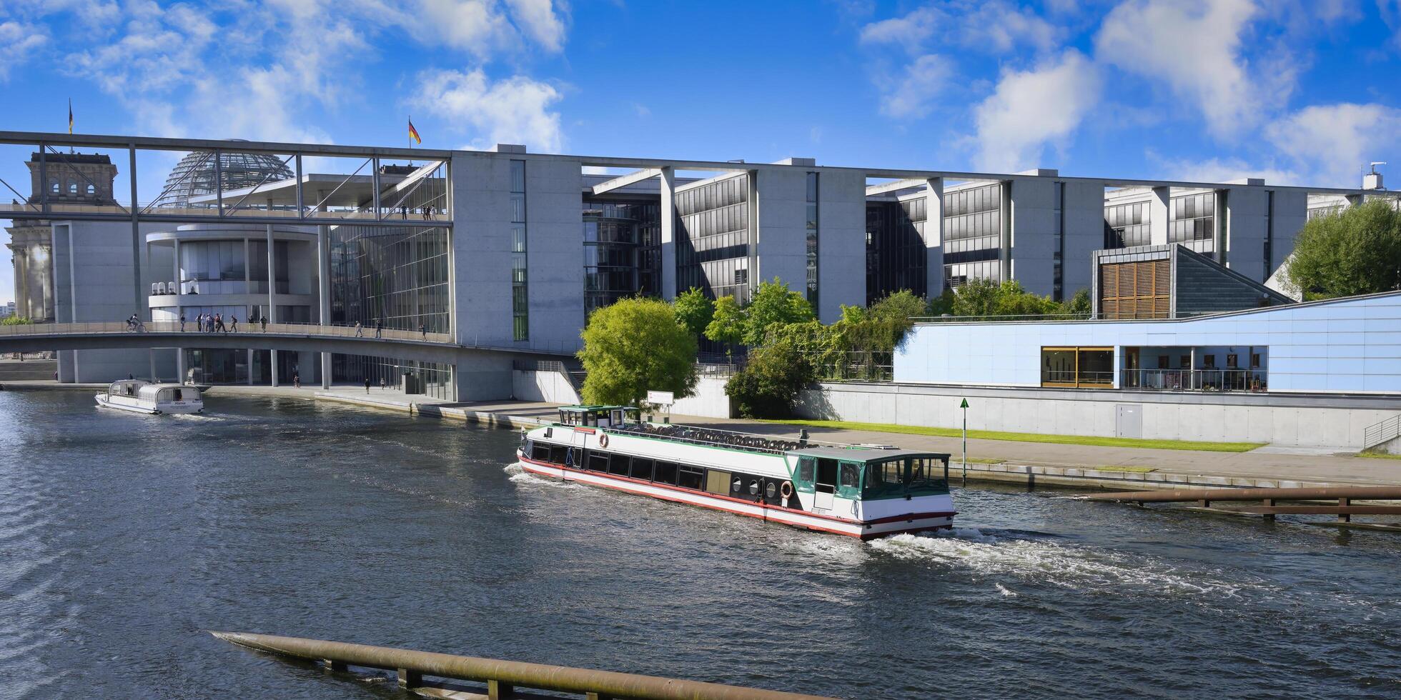 Berlin, Germany, 2021 - Paul Loebe Parliament building along the Spree river and footbridge, Government district in Berlin Mitte, Berlin, Germany photo