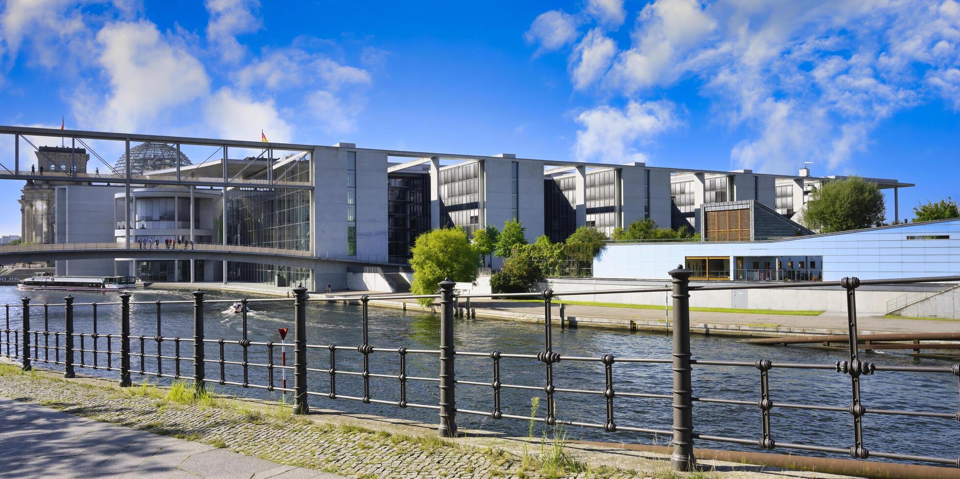 Berlin, Germany, 2021 - Paul Loebe Parliament building along the Spree river and footbridge, Government district in Berlin Mitte, Berlin, Germany photo