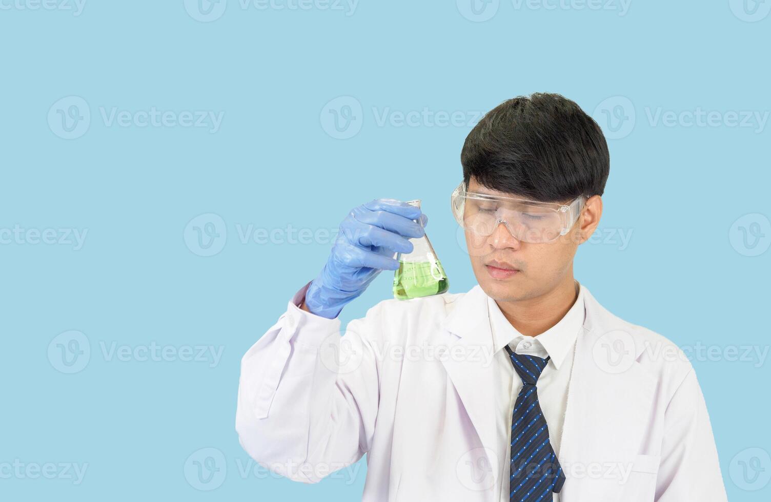 Asian man student scientist in reagent mixing laboratory In a science research laboratory with test tubes of various sizes. on the floor in  laboratory chemistry lab blue background. photo
