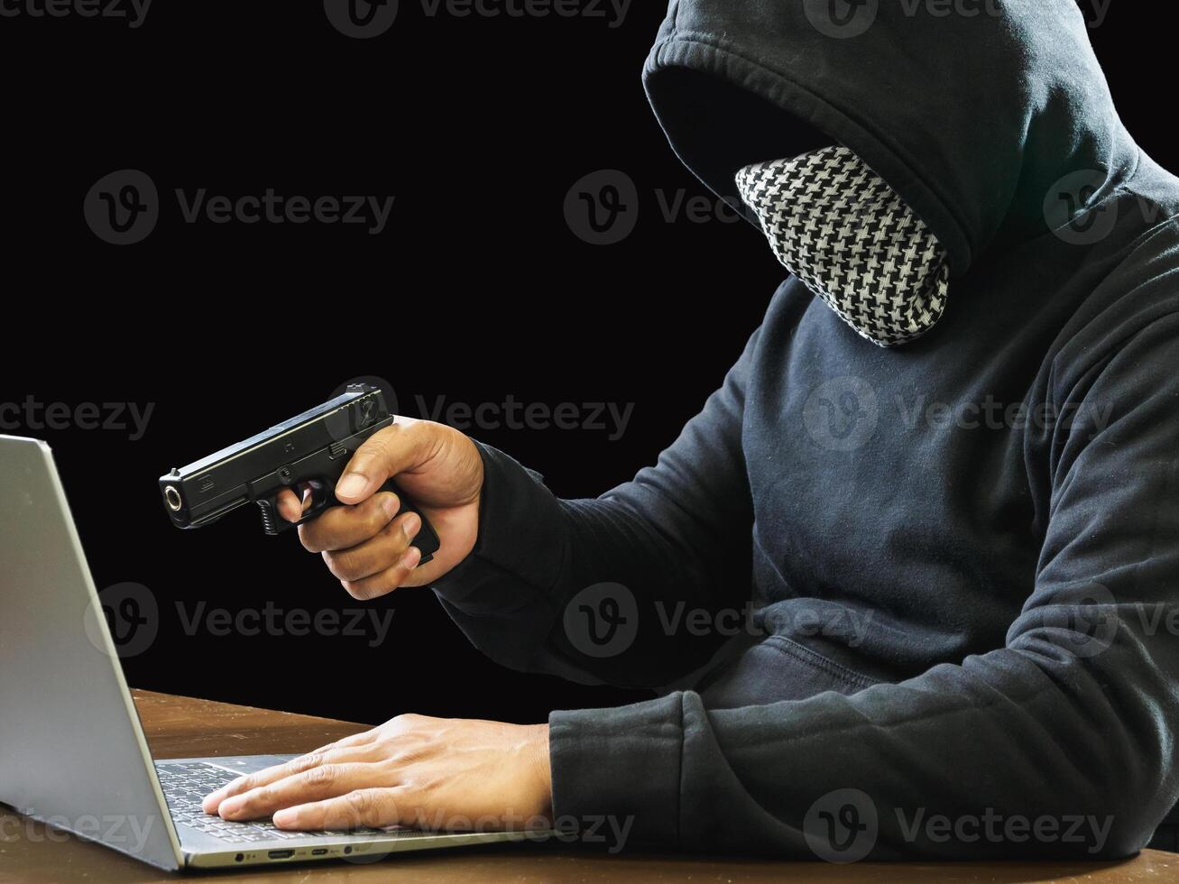 Portrait hacker spy man one person in black hoodie sitting on table looking computer laptop used login password attack security to data digital internet network system night dark background copy space photo