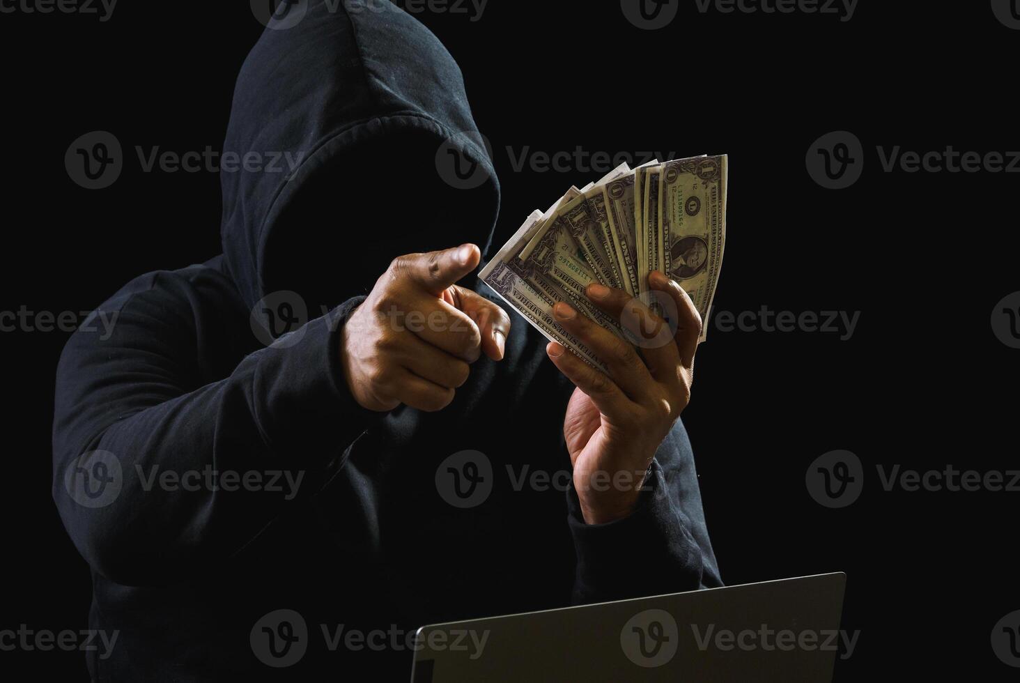 Portrait hacker spy man one person in black hoodie sitting on table looking computer laptop used login password attack security to data digital internet network system night dark background copy space photo