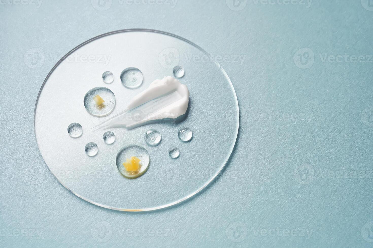 Gel, serum and a cream on a transparent round stand on a blue background. photo