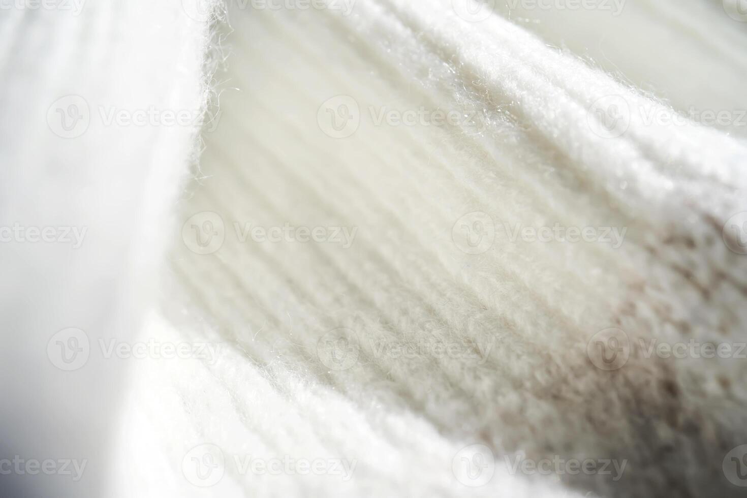 The texture of a warm sweater with a beige pattern. photo