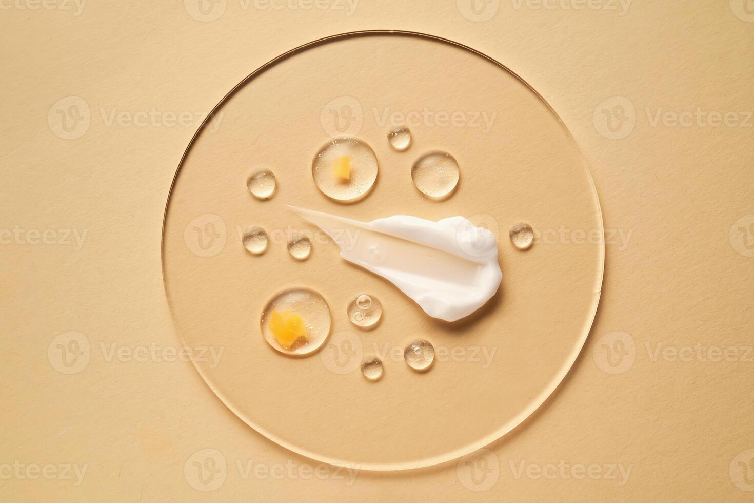 Gel, serum and a cream on a transparent round stand on a beige background. photo