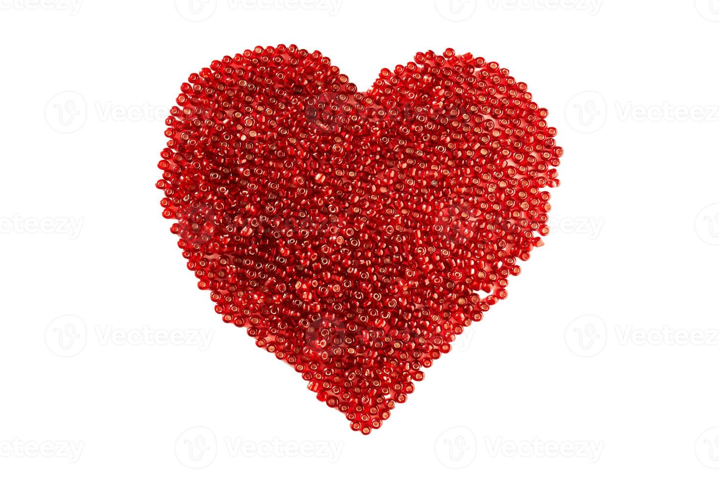 Heart made of red beads on an isolated white background. photo