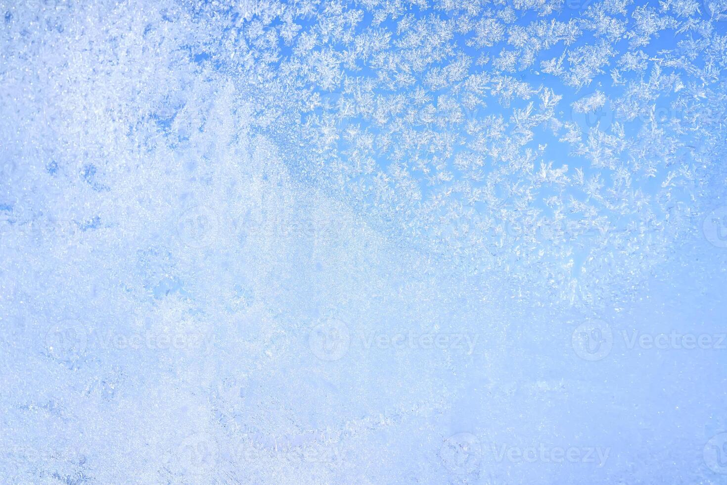 Abstract winter background. Frost on a frozen window against the blue sky. photo