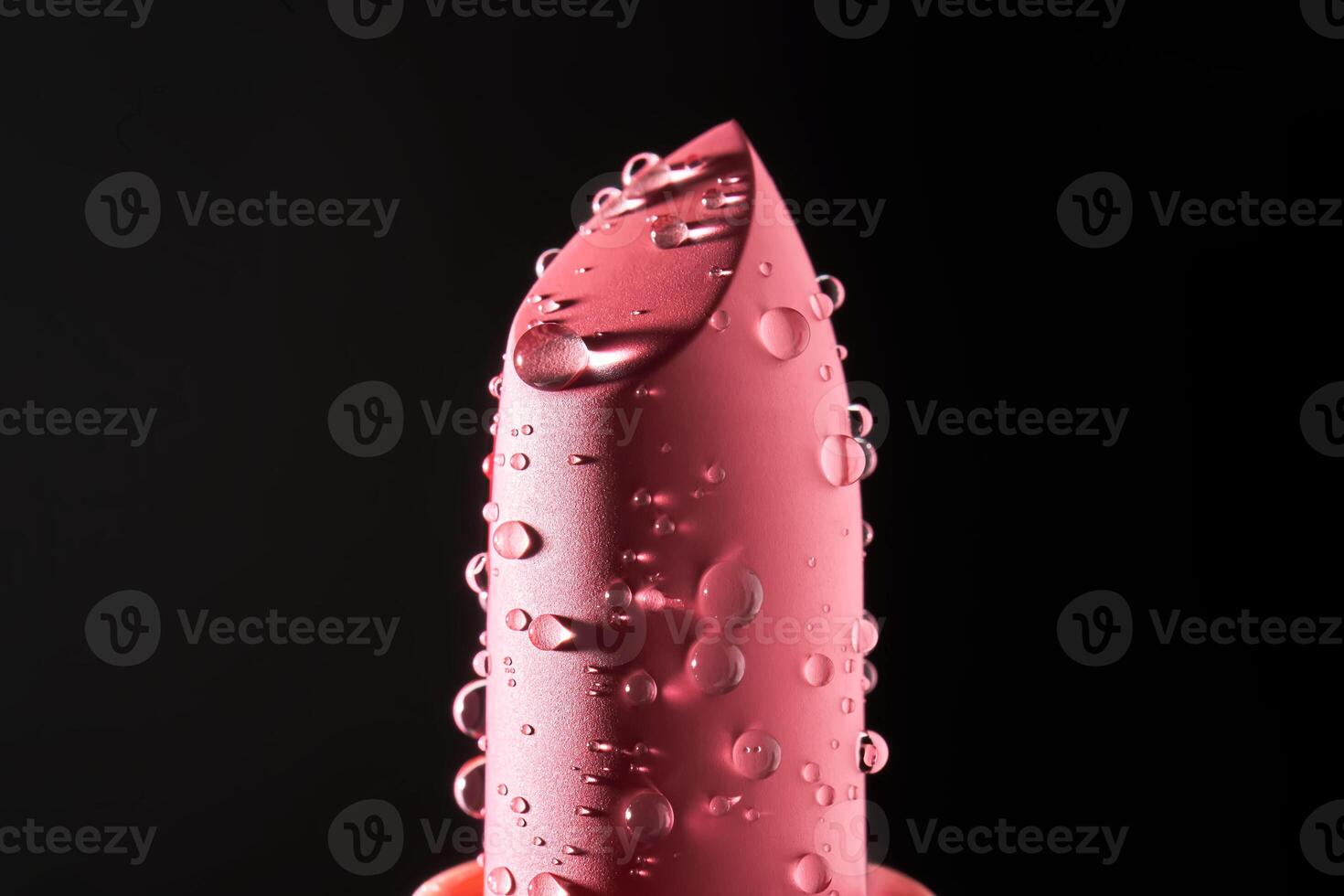 Red lipstick with water drops on a dark background. photo