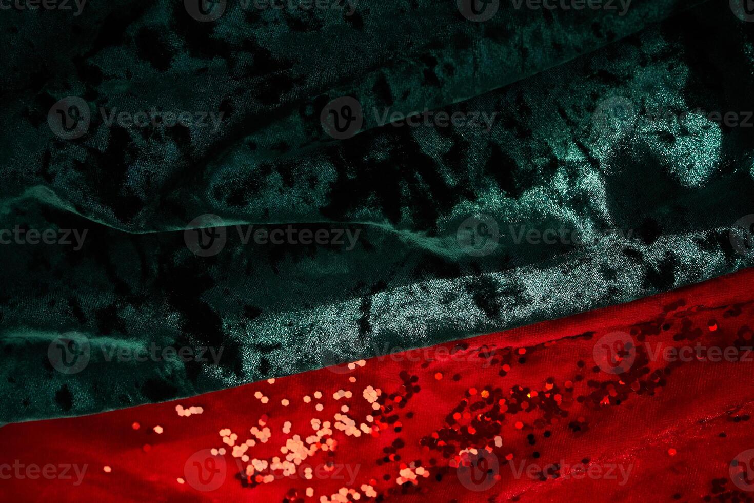 Abstract Christmas background. Red and green velvet fabric with red sparkles. photo