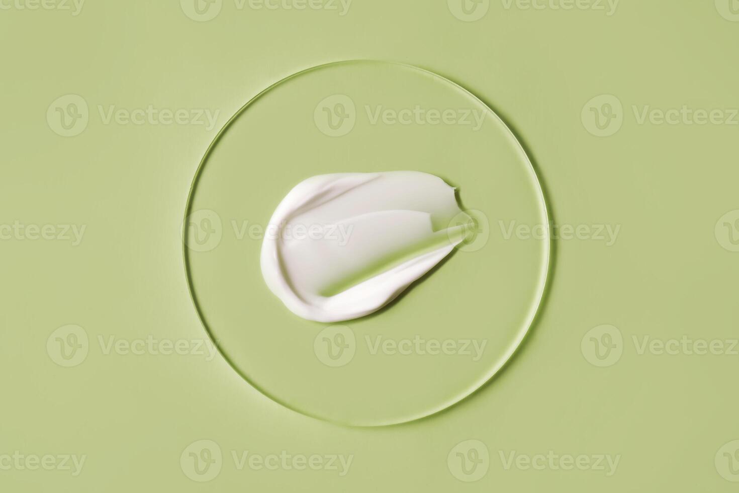 A savory smear of white cream on a green background. photo