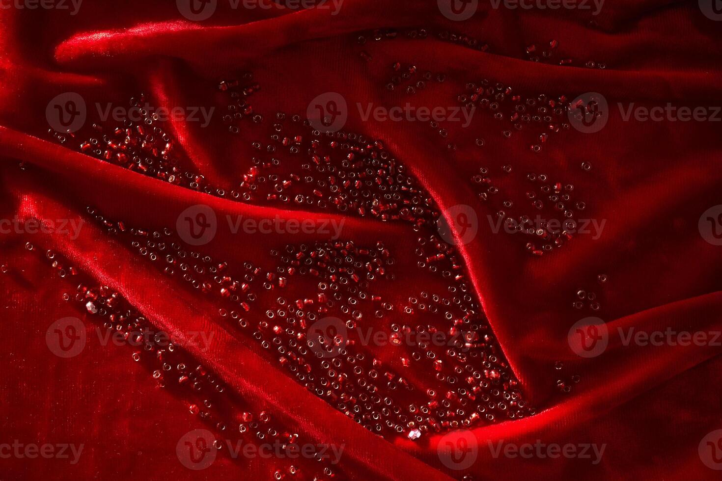 Abstract background from red beads on red velvet. photo