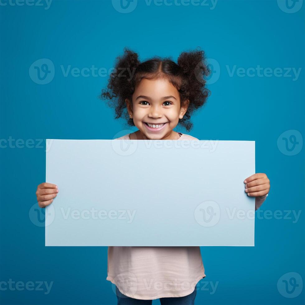 AI generated smiling little girl holding blank white sheet of paper on blue background photo