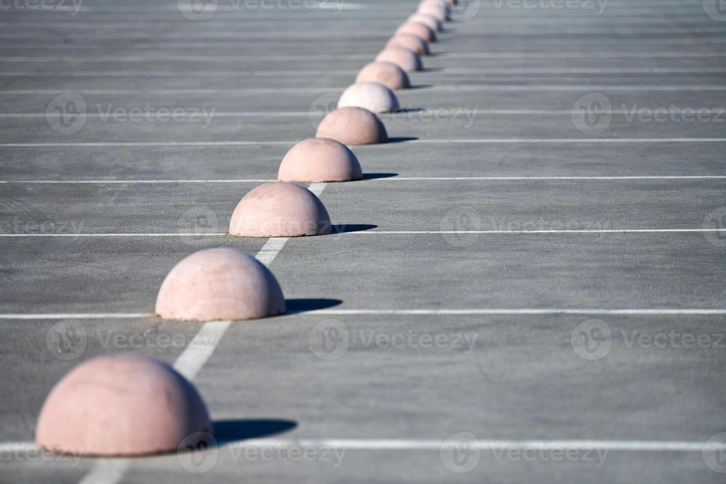 Concrete hemispheres parking limiter. Protection from car parking. Elements to restrict access to parking zone and control movement of vehicles photo
