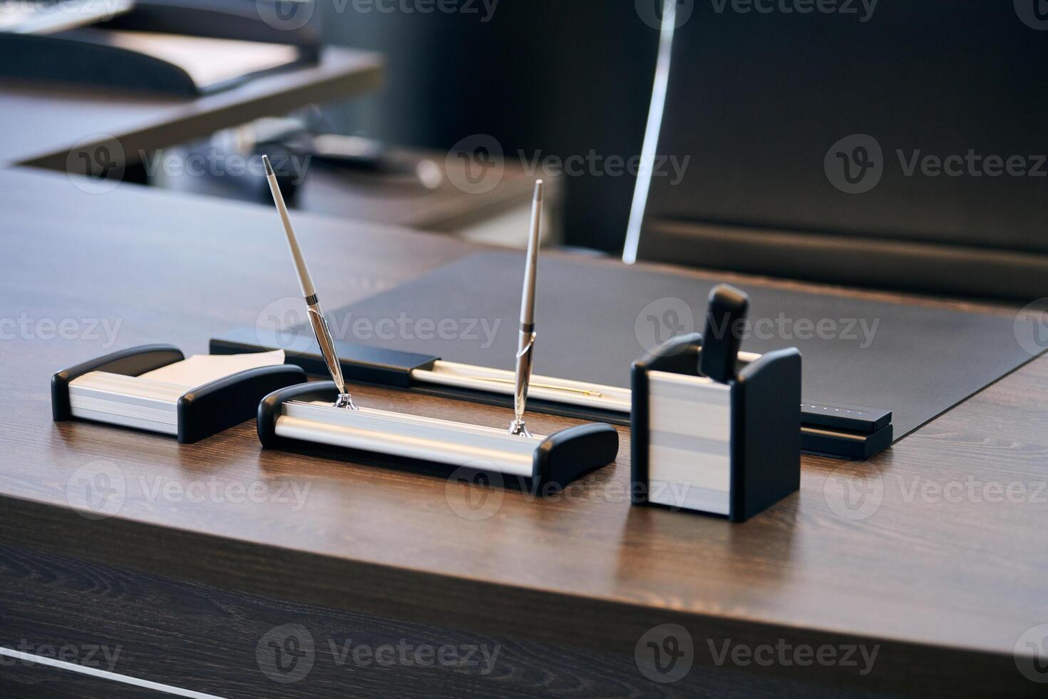 Office workplace with stationery. Boss, chief, supervisor or head of company working place in modern office. Comfortable work table and leather computer chair. photo