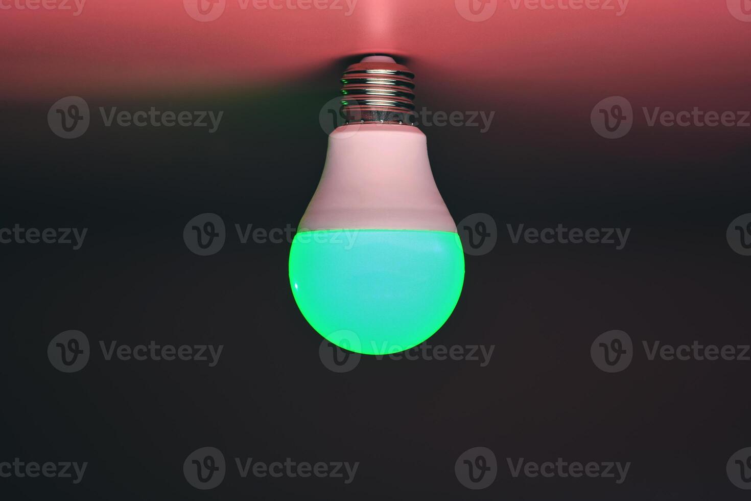 Energy saving light bulb, green light glowing, copy space. Minimal idea concept. photo