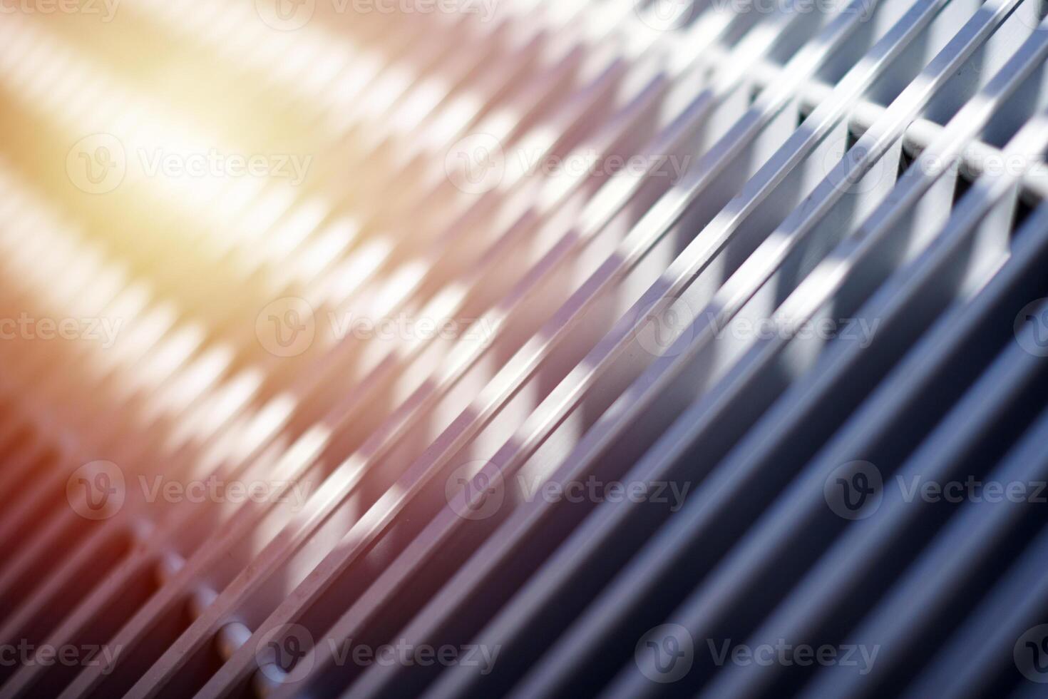 Grill of heating radiator in office, close up. White heat exchangers. Iron aluminium lattice of radiator. photo