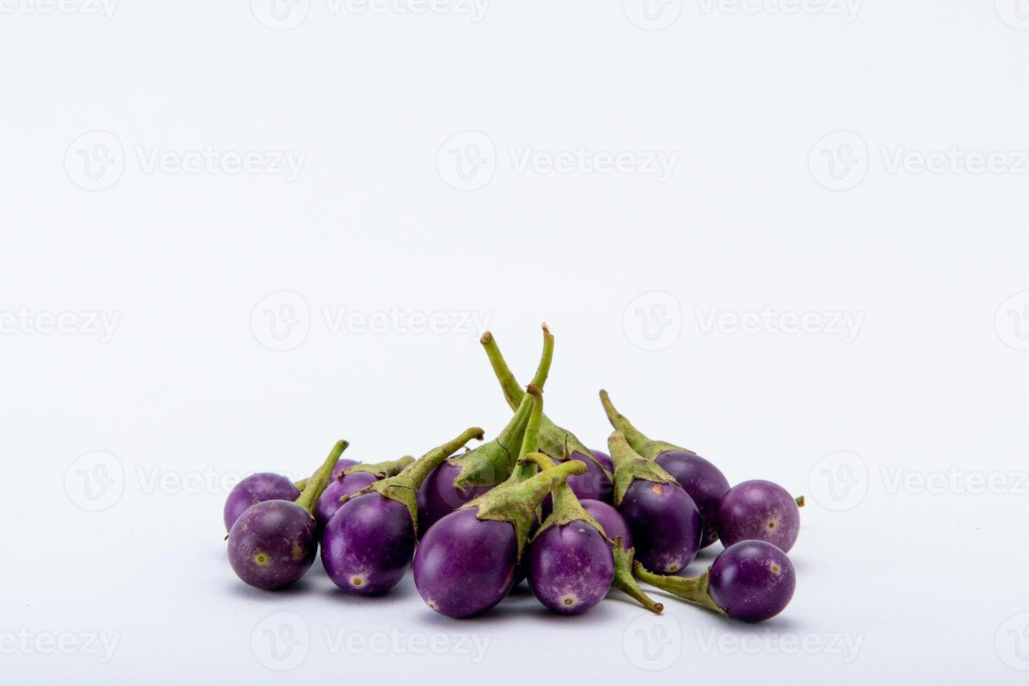 Purple brinjals on the white background. photo