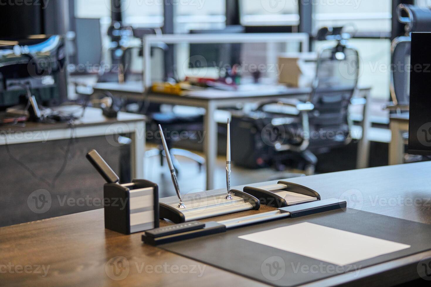 Modern office work place in large corporation. Comfortable work table with stationery, leather computer chair. Boss, chief, supervisor or head of company working place. photo