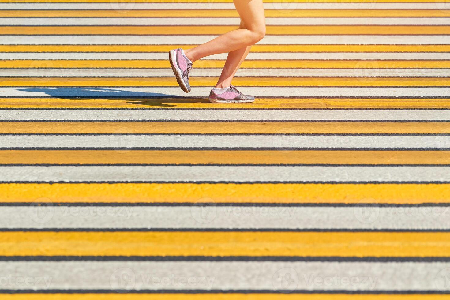 Woman running crosswalk, copy space photo