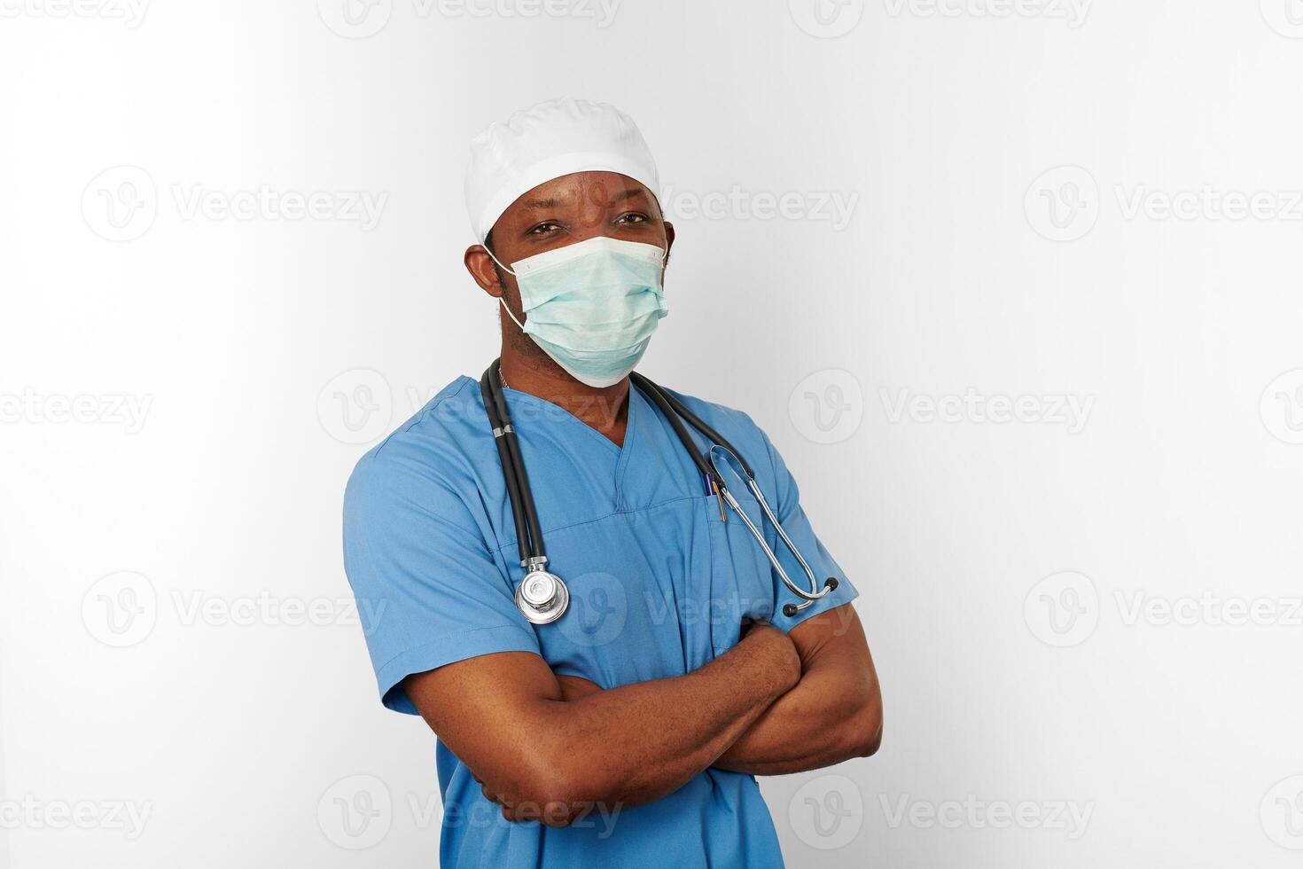 Black surgeon doctor man in blue coat white cap and surgeon mask isolated on white background photo