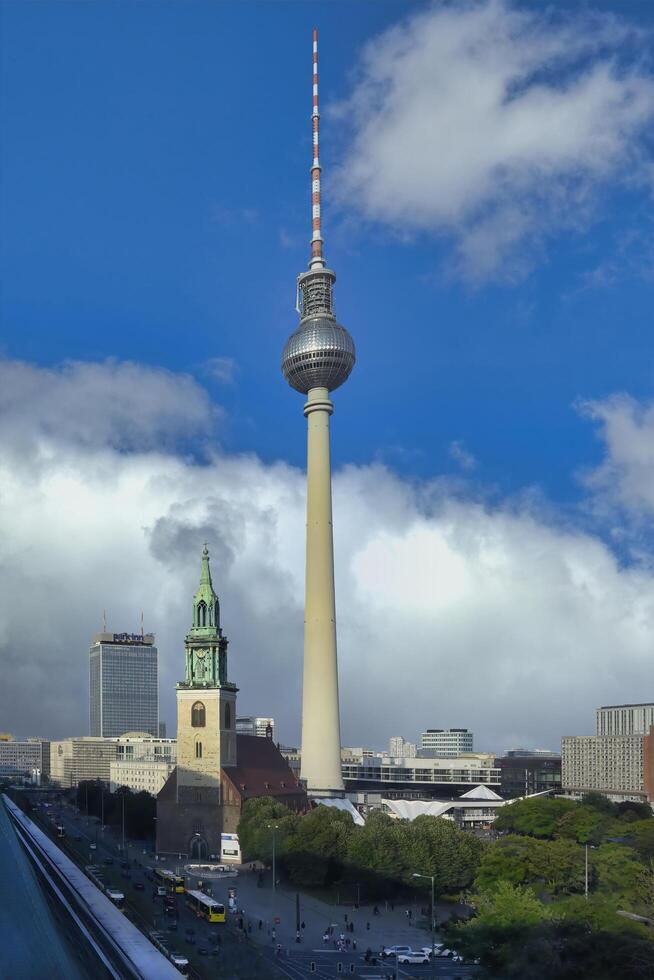 Berlin, Germany, 2021 - Berlin Television tower and Saint Mary Church, Berlin Mitte district, Berlin, Germany photo
