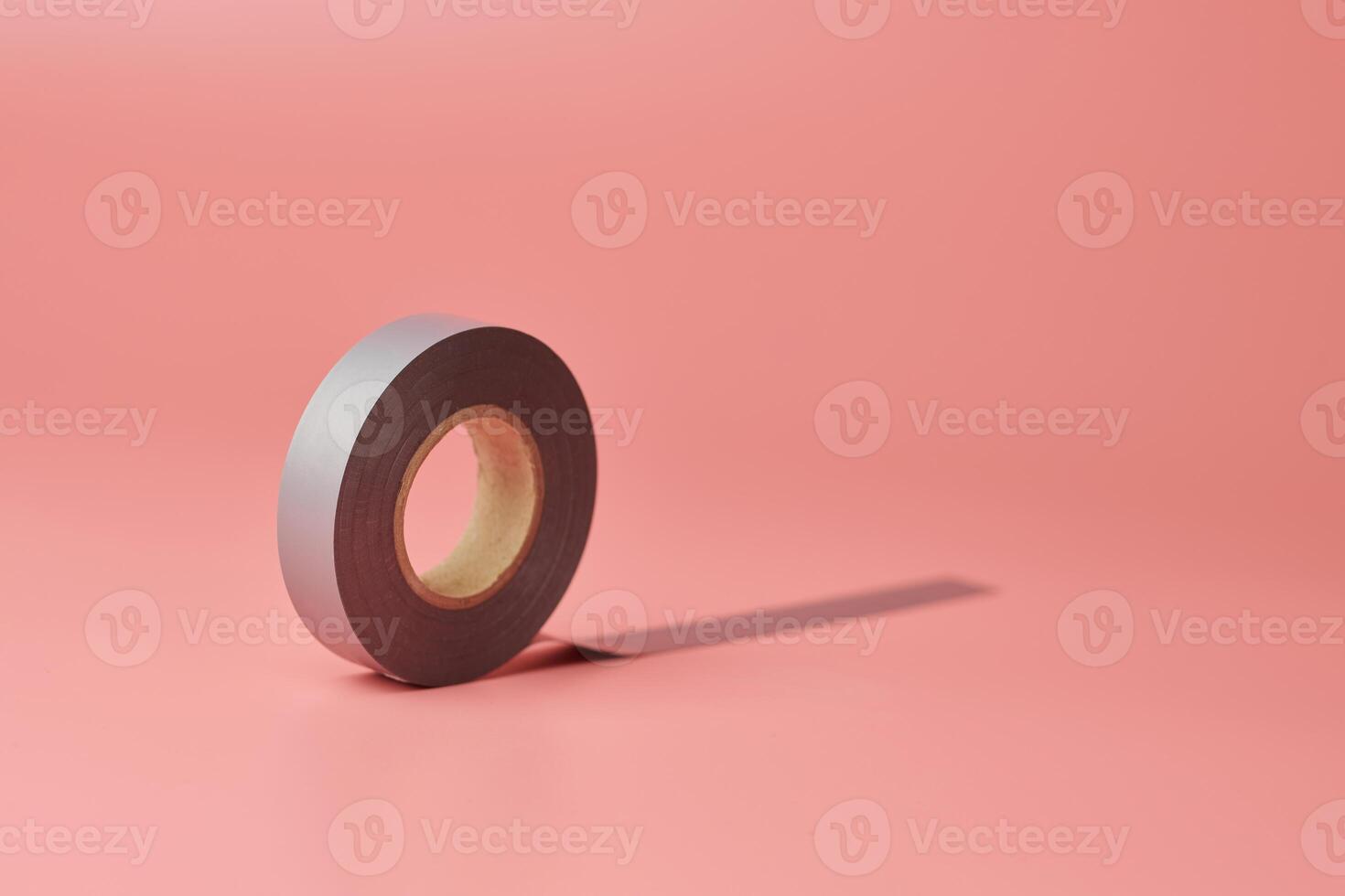 Electrical tape roll, copy space. Minor repairs in house concept. Minimal pink background. photo